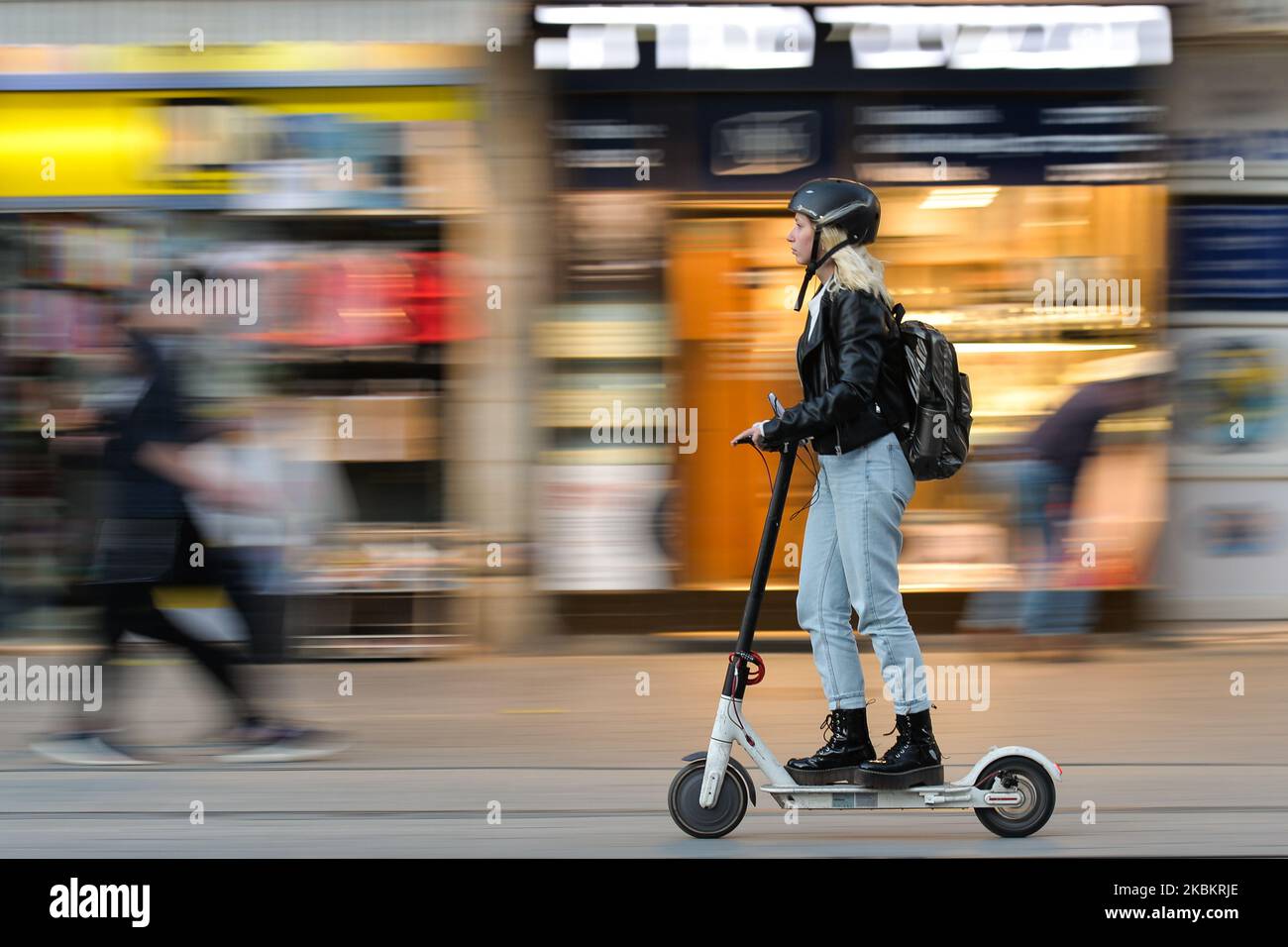 A young lady seen on electric scooter on Jaffa Street, in Jerusalem's