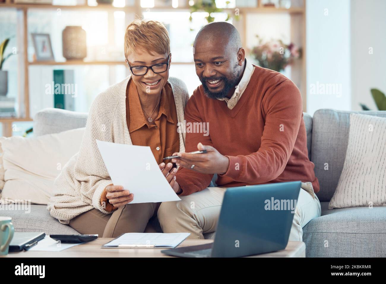 Finance, paperwork and happy black couple on sofa check bank account