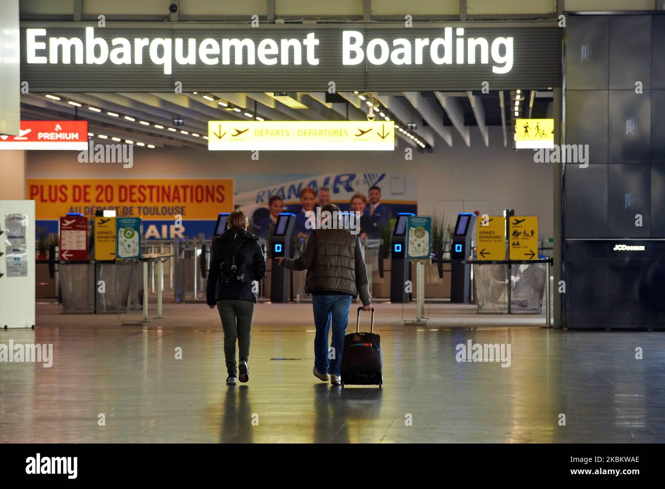 Two people go to the boarding gate at the ToulouseBlagnac airport in