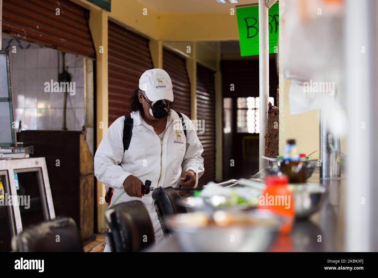 Staff from the Coyoacán Mayor's Office, in Mexico City, carried out sanitation work to stop the spread of Covid-19, in various public markets such as the 'Ajusco Moctezuma' market, on April 2, 2020. (Photo by Cristian Leyva/NurPhoto) Stock Photo