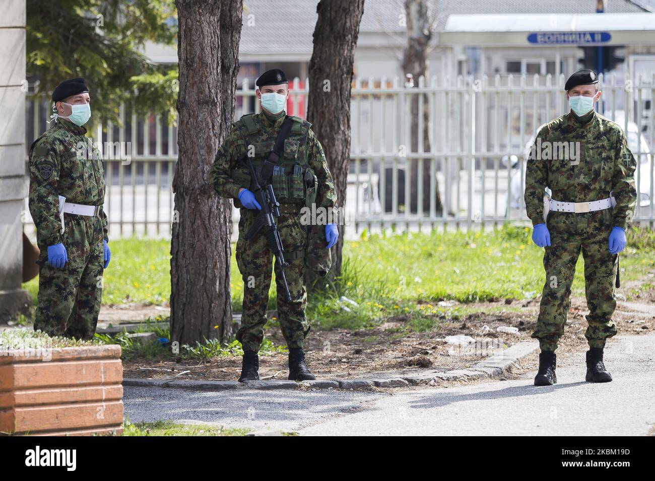 Serbian army soldiers stand guard in front of the Clinic for Infectious and Tropical Diseases during a curfew imposed to prevent the spread of coronavirus disease (COVID-19) in Kragujevac, Serbia on April 5, 2020. (Photo by Nikola Krstic/NurPhoto) Stock Photo