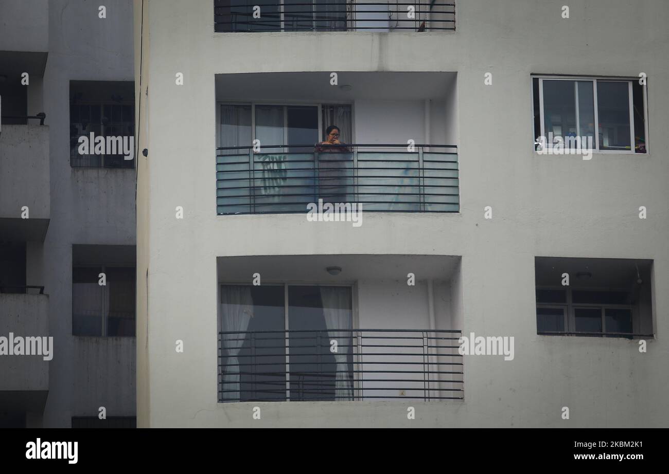 A Nepalese woman looks outside from the balcony at a residential compound during the fourteenth day of nationwide lockdown in an effort to control the spread of COVID-19 in Lalitpur, Nepal, Monday, April 6 , 2020. (Photo by Saroj Baizu/NurPhoto) Stock Photo