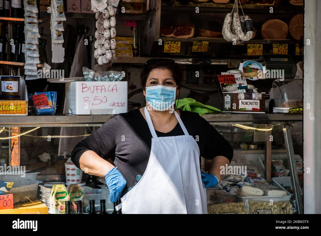 Food workers wear a face mask as a preventive measure against the COVID