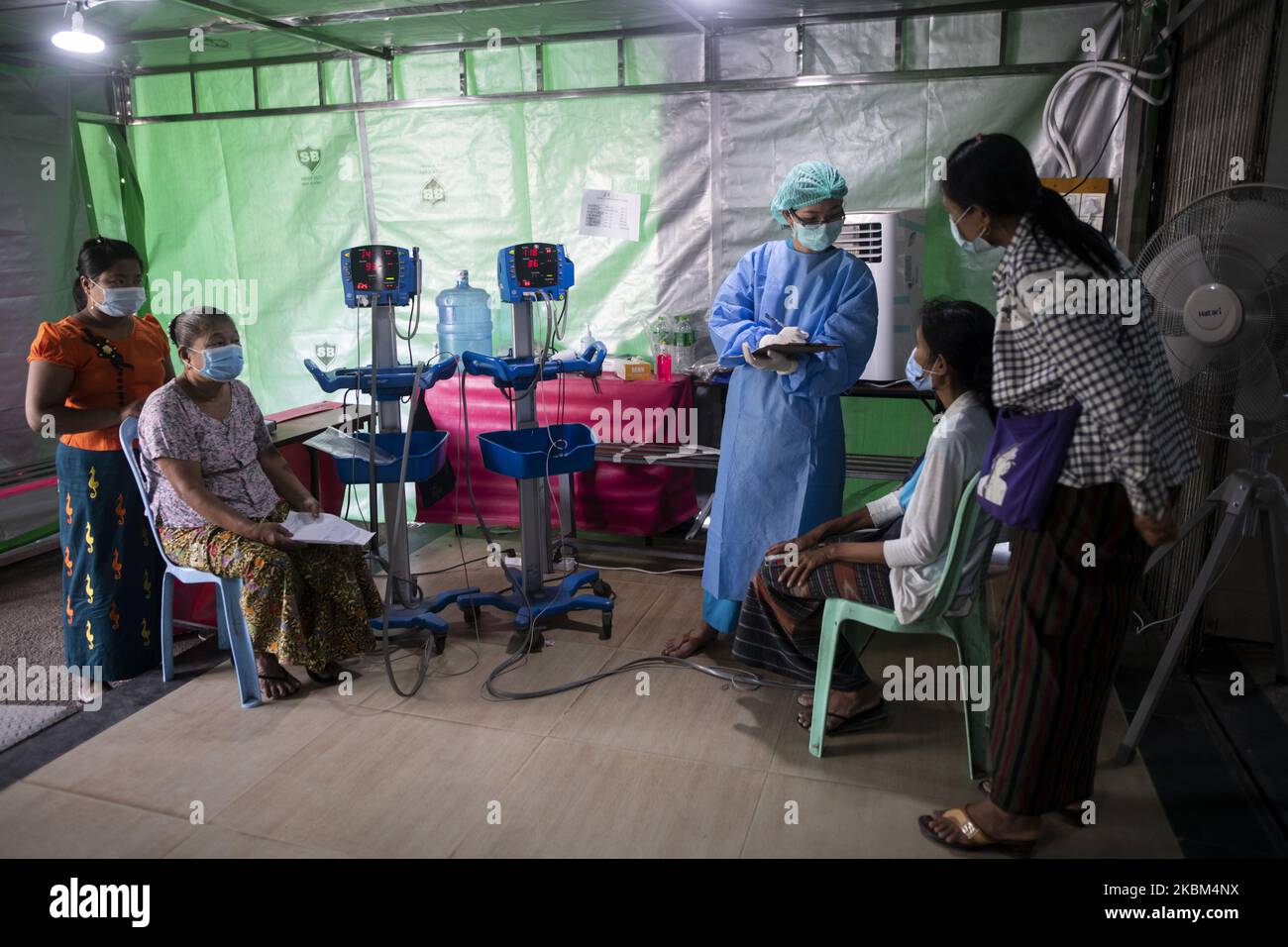 A medical worker checks a patient at the entrance of Yangon General Hospital in Myanmar, April 7, 2020. (Photo by Shwe Paw Mya Tin/NurPhoto) Stock Photo