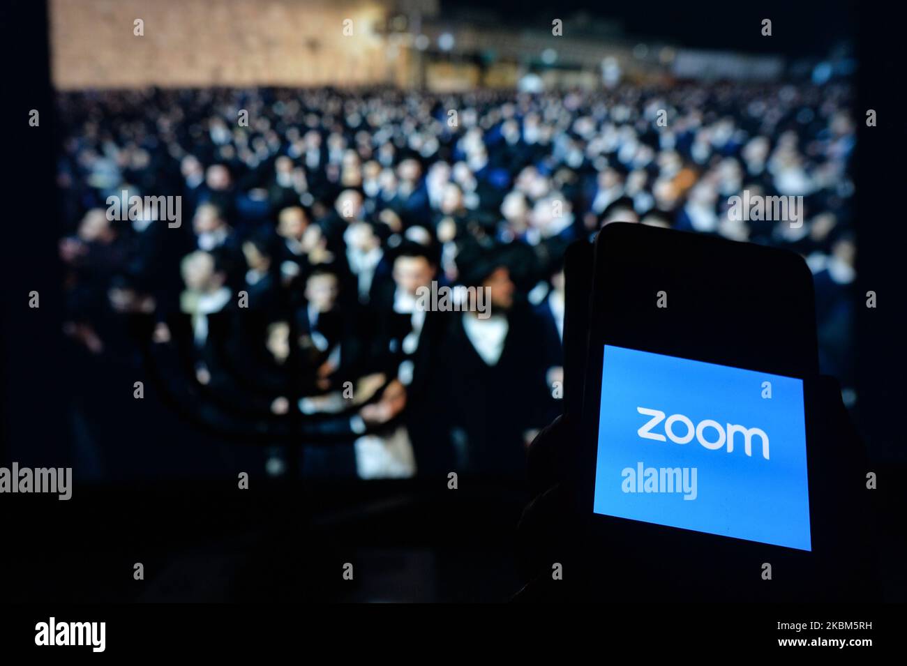 Zoom app displayed on a mobile phone. Passover, also known as 'Pesach, in Hebrew, is one of the most important festivals in the Jewish calendar and commemorates God liberating Jews from slavery in ancient Egypt This year Passover lasts from Wednesday 8 to Thursday 16 April, but celebrations will be unusually muted due to the coronavirus pandemic. On Wednesday, April 8, 2020, in Krakow, Poland. (Photo by Artur Widak/NurPhoto) Stock Photo