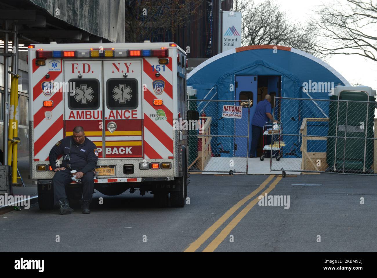 An ambulance driver waits outside the entrance to the makeshift COVID19