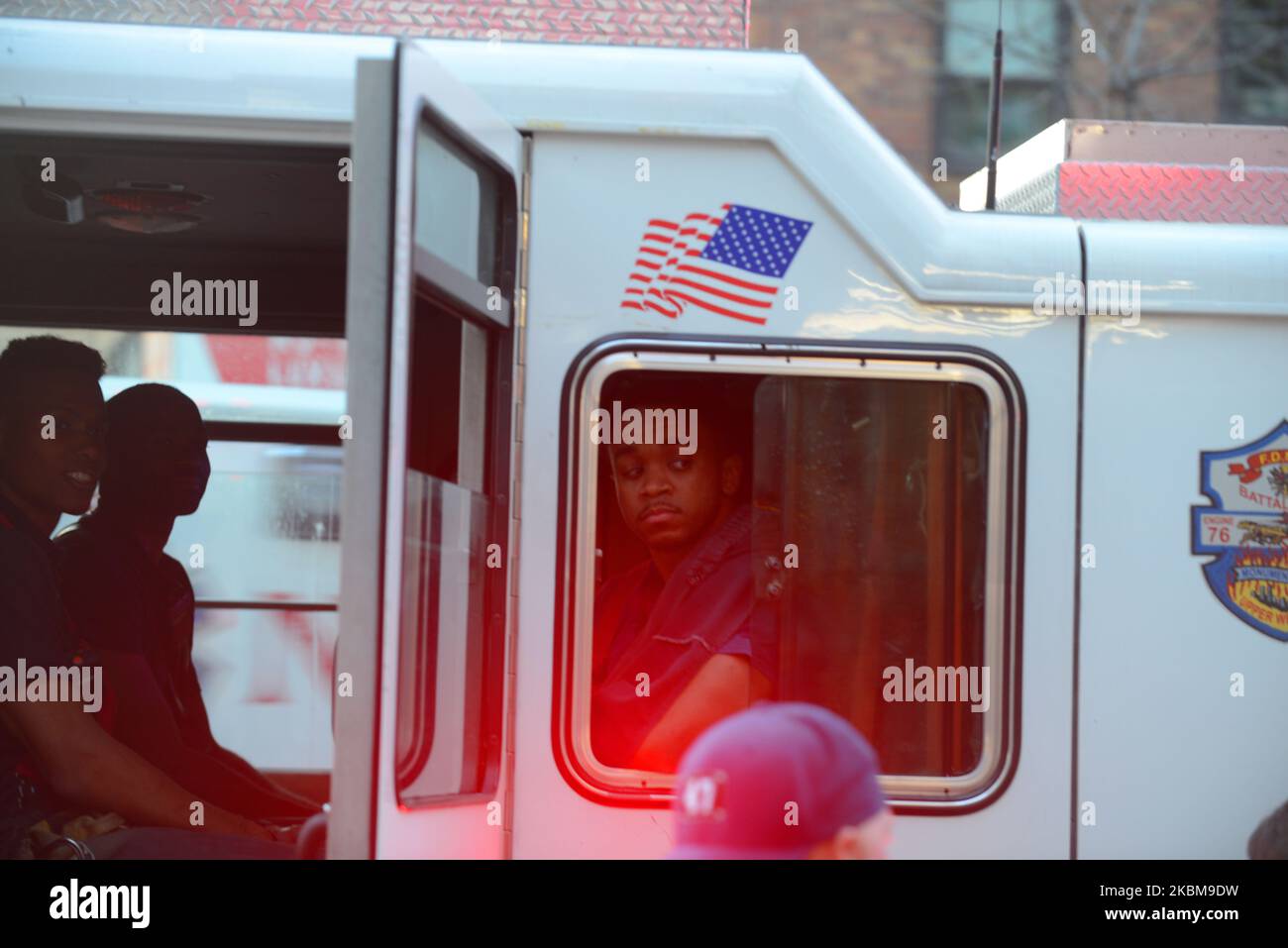 A firefighter waits in his truck outside Mount Sinai Hospital in uptown