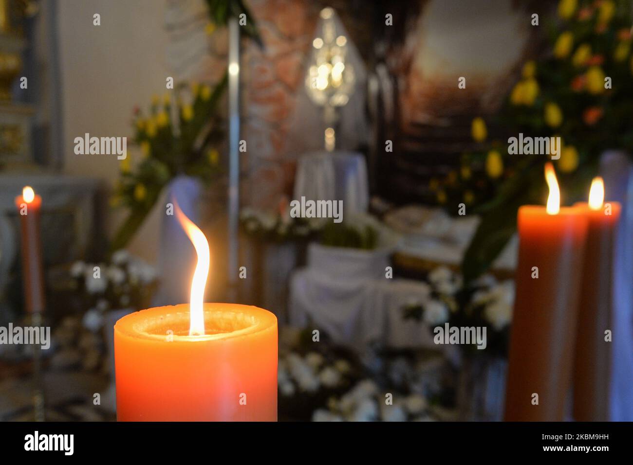 Candles around the tomb of Christ inside an empty church of Saint