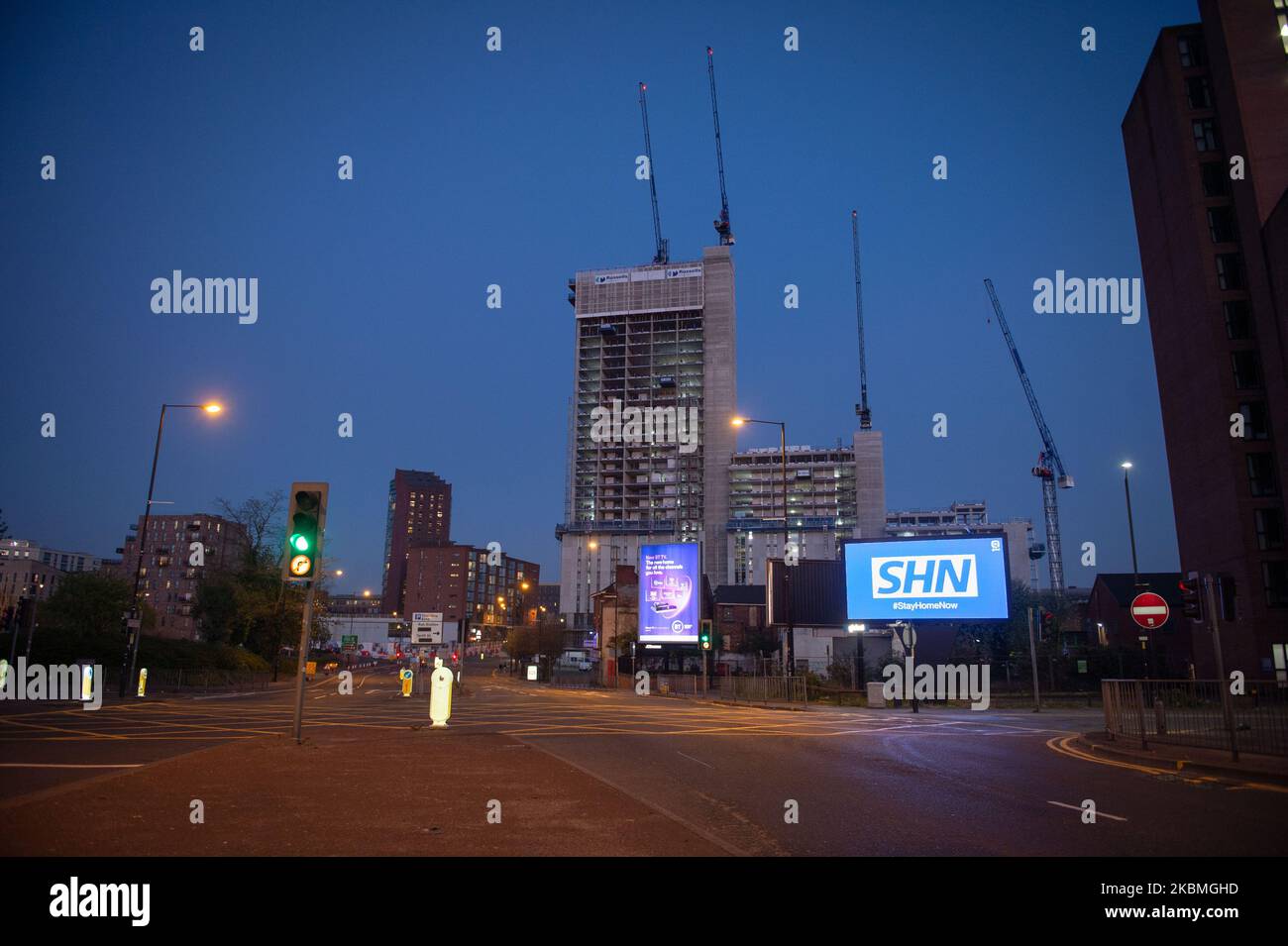 A billboard with the NHS logo rotated 180 degrees to warn motorists to STAY HOME NOW on Great Ancoats Street at twilight in Manchester city centre, UK on April 15, 2020. (Photo by Pat Scaasi/MI News/NurPhoto) Stock Photo