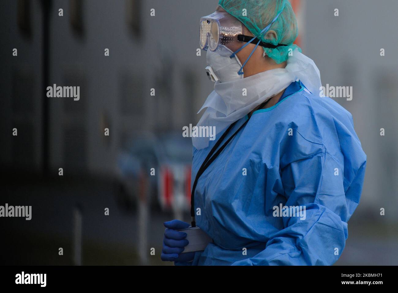 A medical staff member of the University Hospital in Krakow, one of 19 hospitals in Poland that are being transformed into infectious hospitals for coronavirus patients, seen outside the main hospital building. On Friday, March 17, 2020, in Krakow, Poland. (Photo by Artur Widak/NurPhoto) Stock Photo