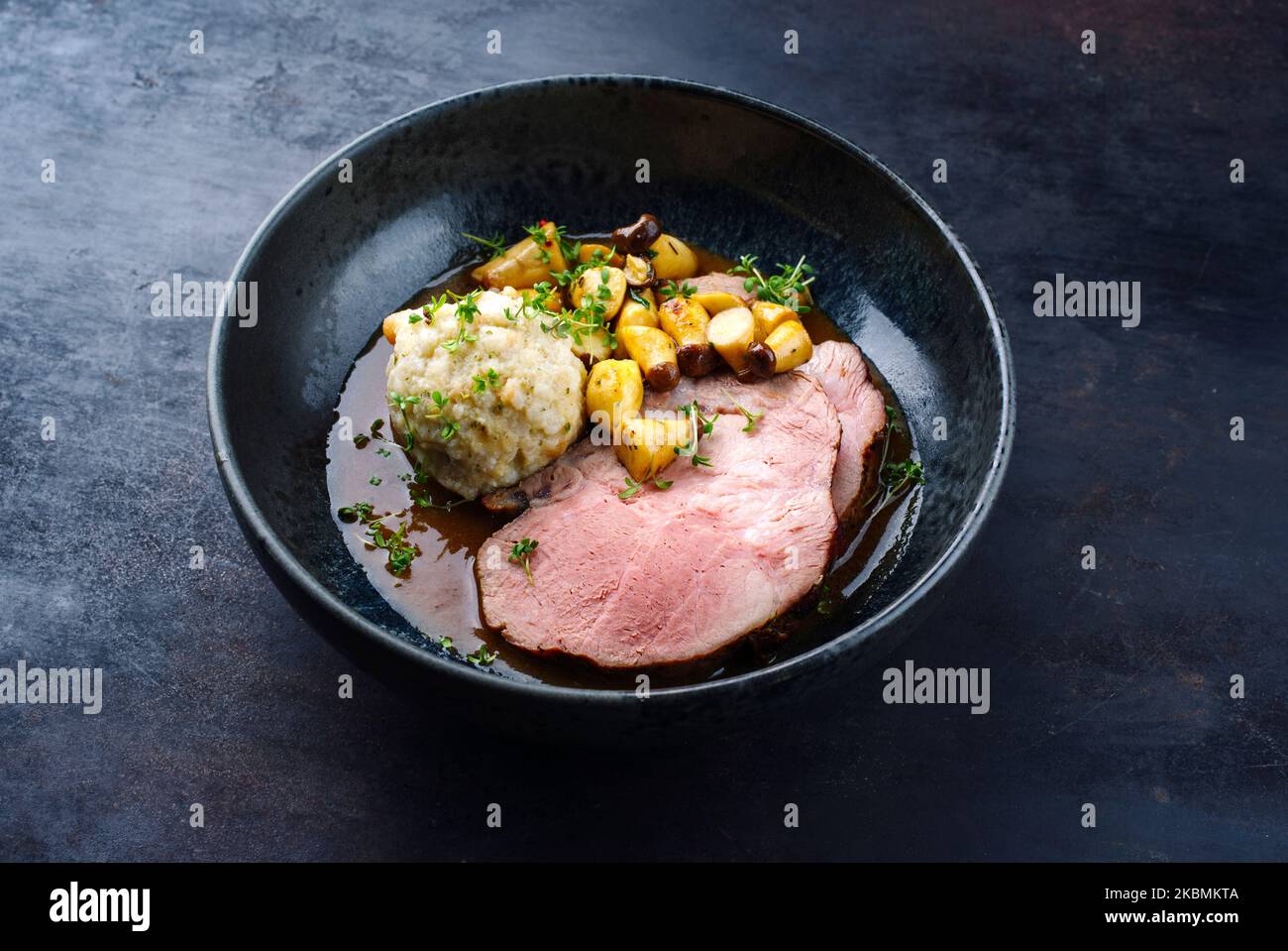 Traditional German pork roast served with bread dumpling and king