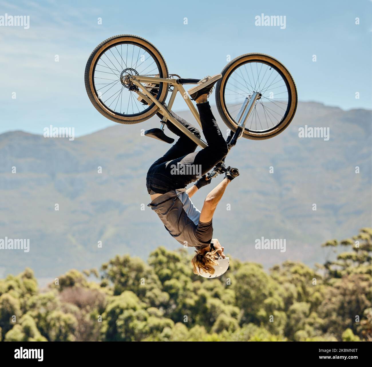 Mountain bike, man and upside down air jump, action and bicycle stunt