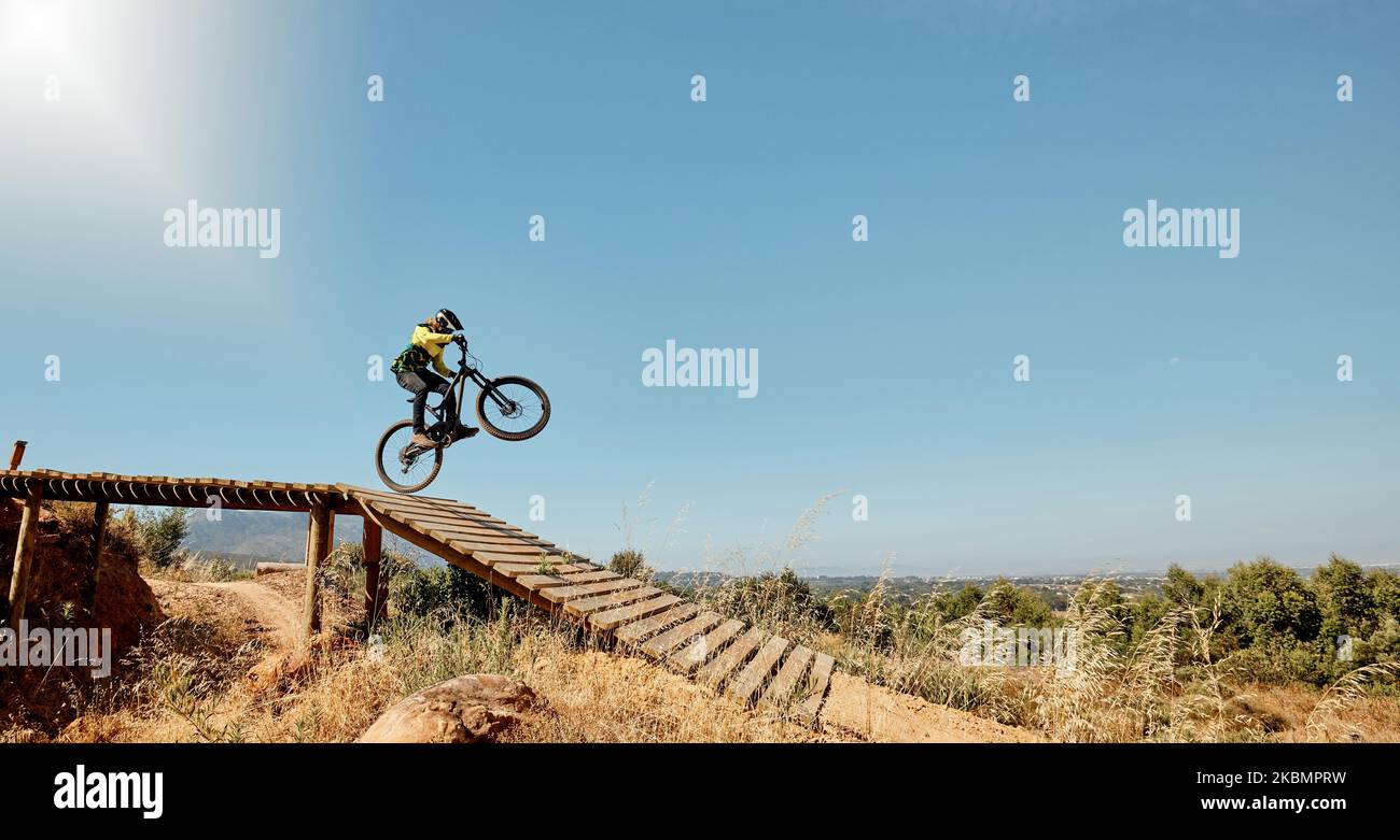 Sports, mountain bike and ramp jump in nature, cycling .and outdoors