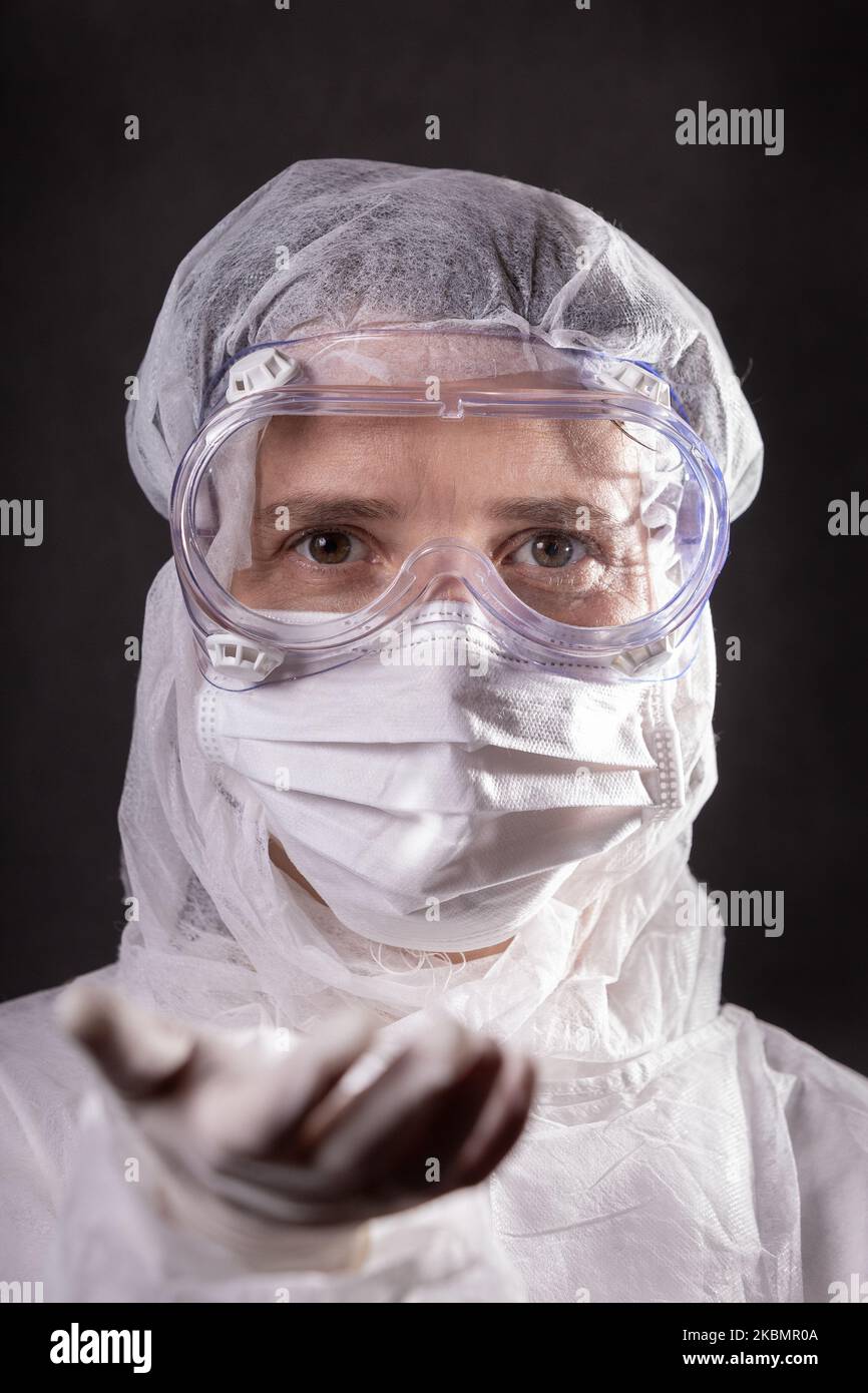For illustration purposes woman wears Personal Protective Equipment