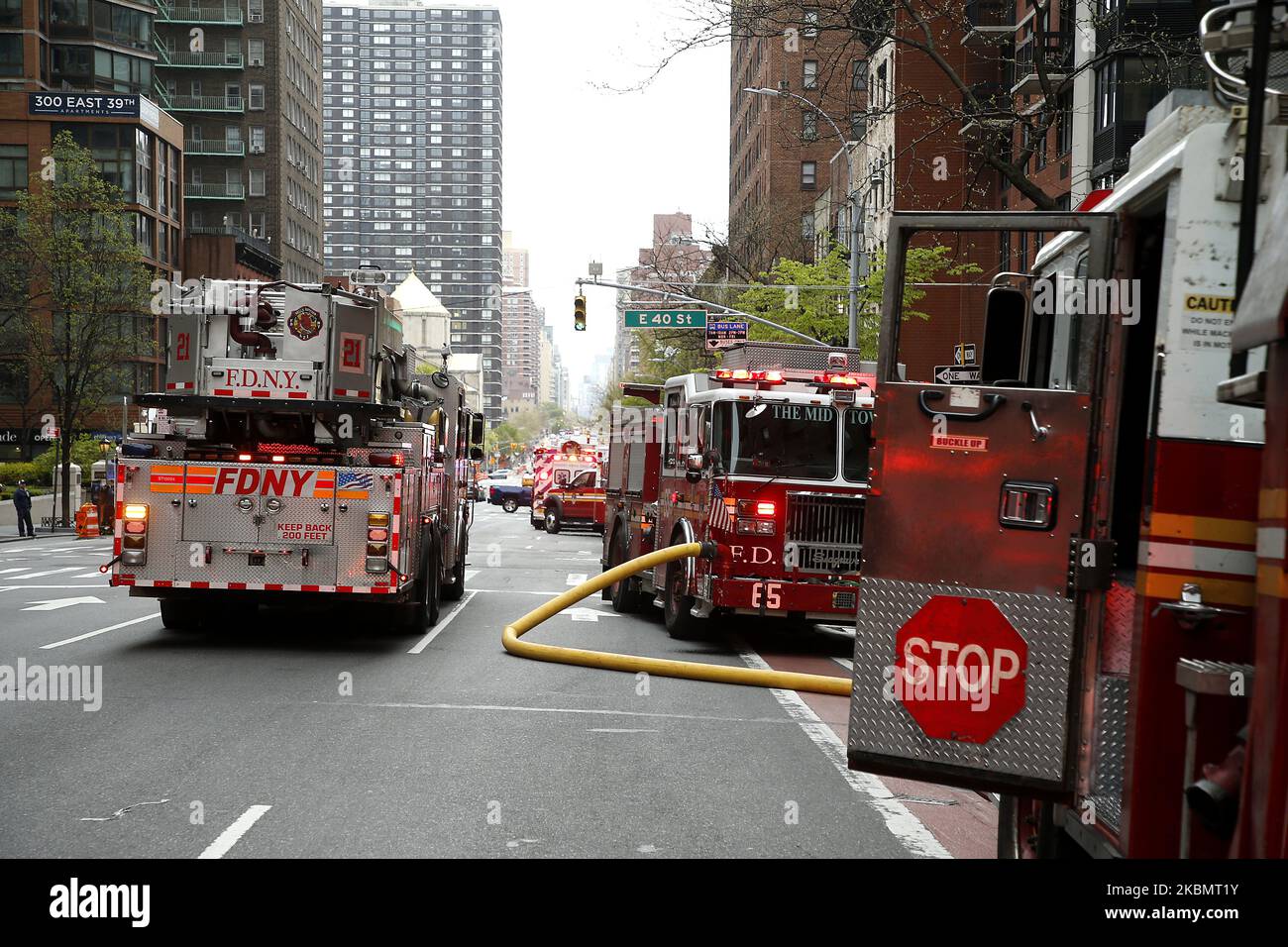 Fire truck stand at the ready in New York, on April 23, 2020. New York Fire Department and Emergency services technicians were dispatched to a high-rise in New York City on April 23, 2020. Scores of firetrucks, ambulances and EMT rescue medics stood ready in front of Murray Hill towers on 2nd Avenue. (Photo by John Lamparski/NurPhoto) Stock Photo