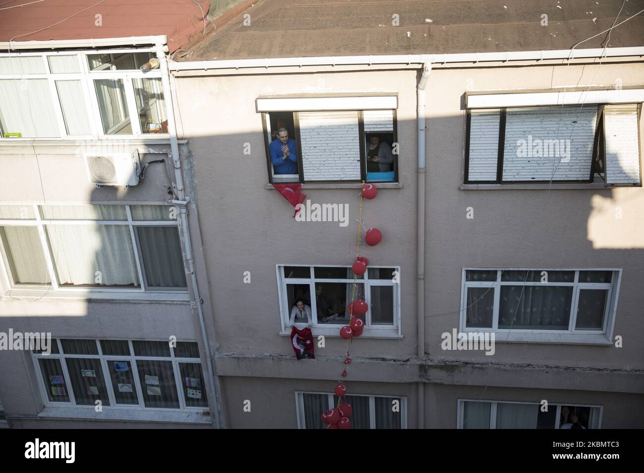 People celebrate with Turkish flags on their balconies to mark the National Sovereignty and Children's Day during a lockdown in Istanbul, Turkey, 23 April 2020. The Turkish Ministry of Interior announced that Istanbul and 30 major cities will be under lockdown from 23 until 26 April 2020 amid the ongoing coronavirus COVID-19 pandemic. Turkey suspended all international flights and all inter-city travels are subject to local authorities' permission as part of measures to prevent the spread of the pandemic COVID-19 disease caused by the SARS-CoV-2 coronavirus. (Photo by Cem TekkeÅŸinoÄŸlu/NurPho Stock Photo