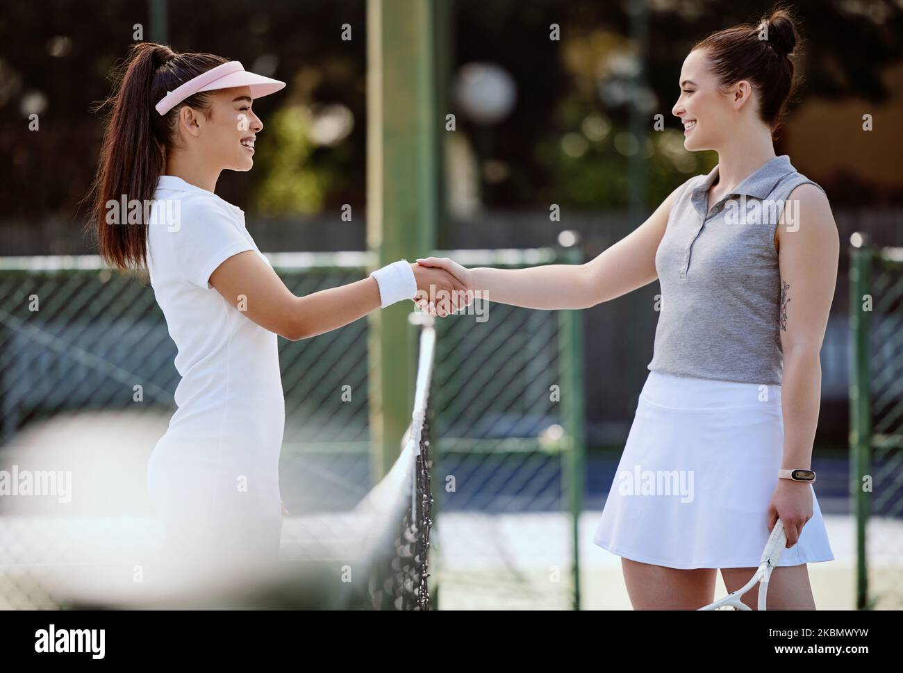 Tennis, sport and women handshake for competition, fitness and exercise on outdoor tennis court for health and active life. Athlete, friendly and Stock Photo