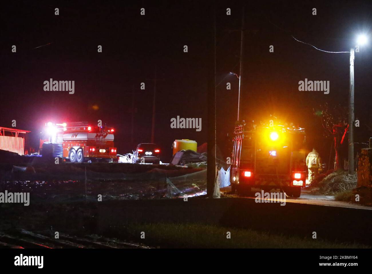 South Korean Fire fighters work to extinguish a blaze on a mountain in