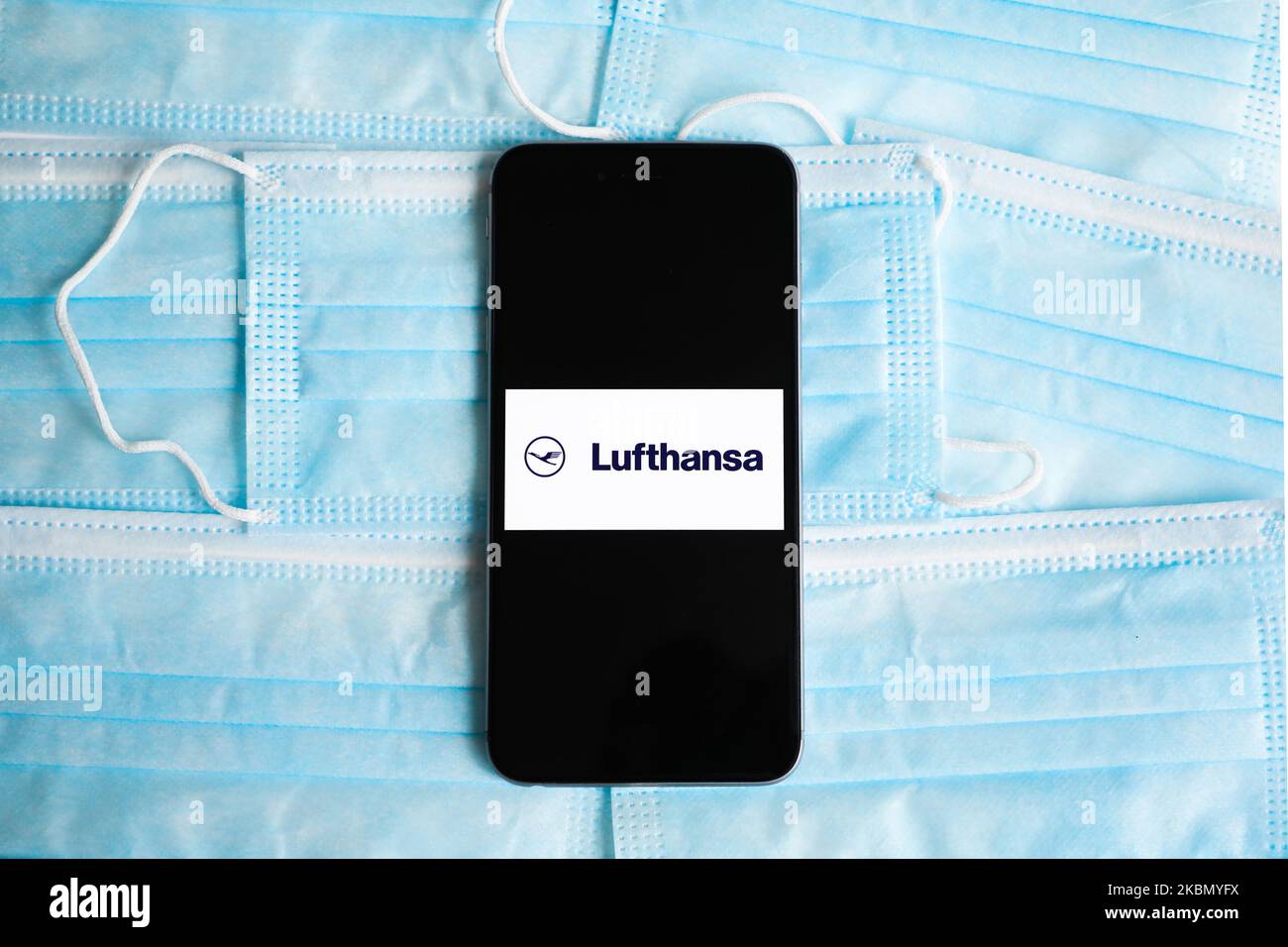Lufthansa logo is displayed on a mobile phone screen photographed on