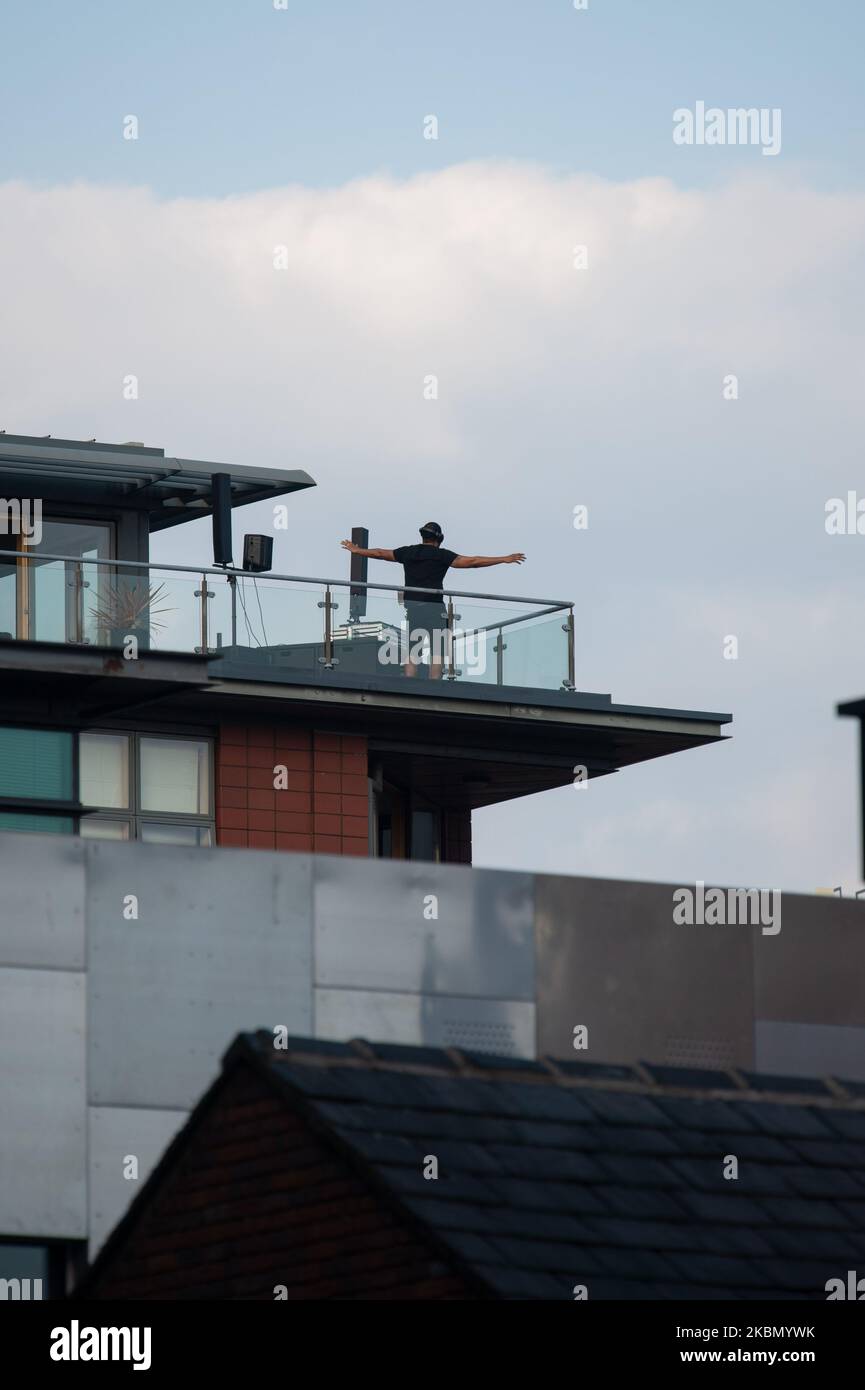 The Ancoats district of Manchester comes to a standstill as DJ Coast2Coast puts on a short DJ set on the top of one of the residential buildings. He is raising funds for The Samaritans and Cyclists Fighting Cancer. On April 25, 2020 in Manchester, UK. (Photo by Pat Scaasi/MI News/NurPhoto) Stock Photo