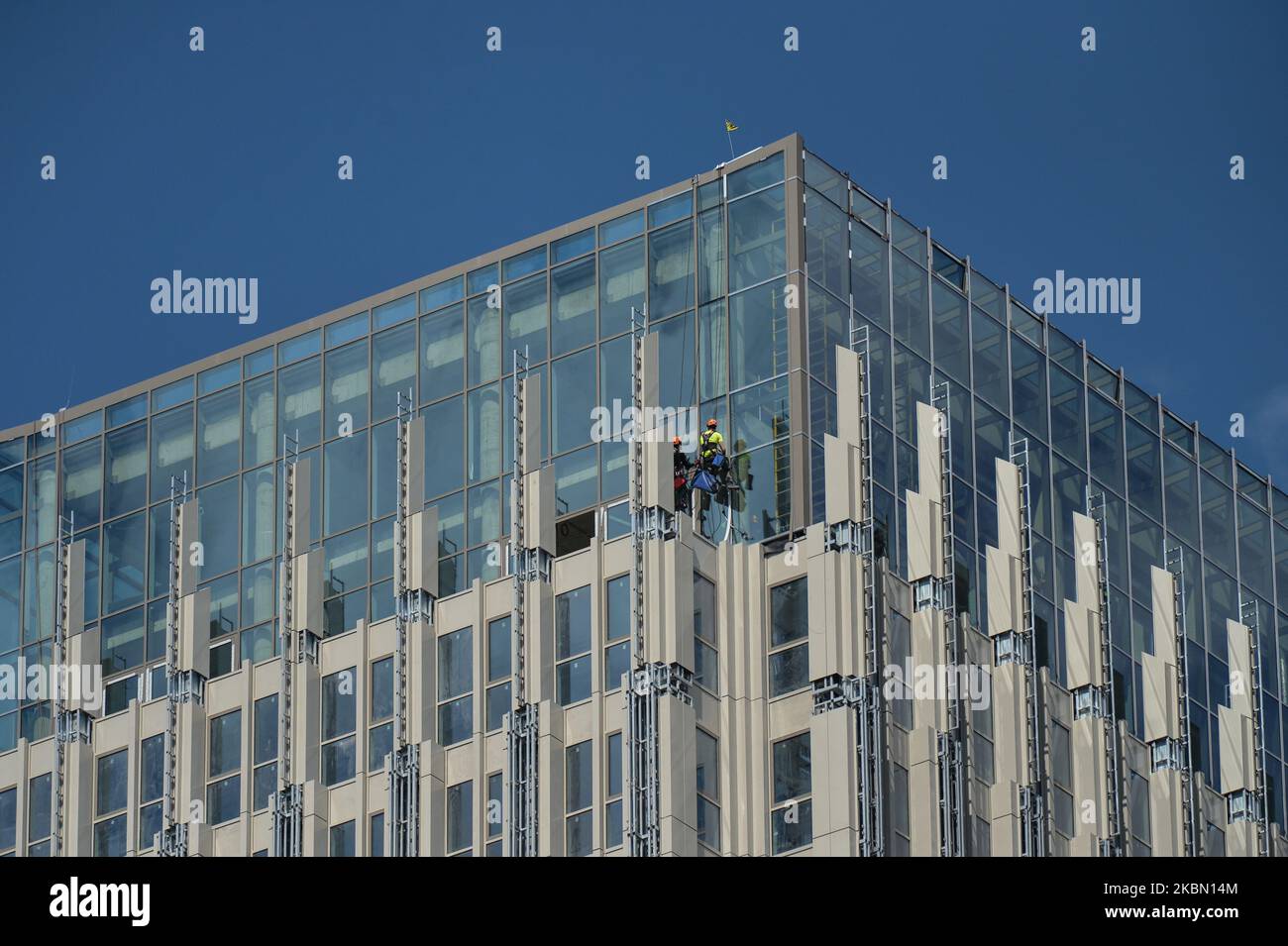 Construction workers seen working on the top of a nearly finished Unity ...