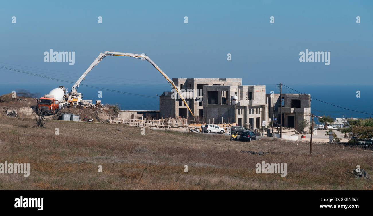 Santorini, Greece. Housing development in island centre, pumping cement to form foundations. Stock Photo