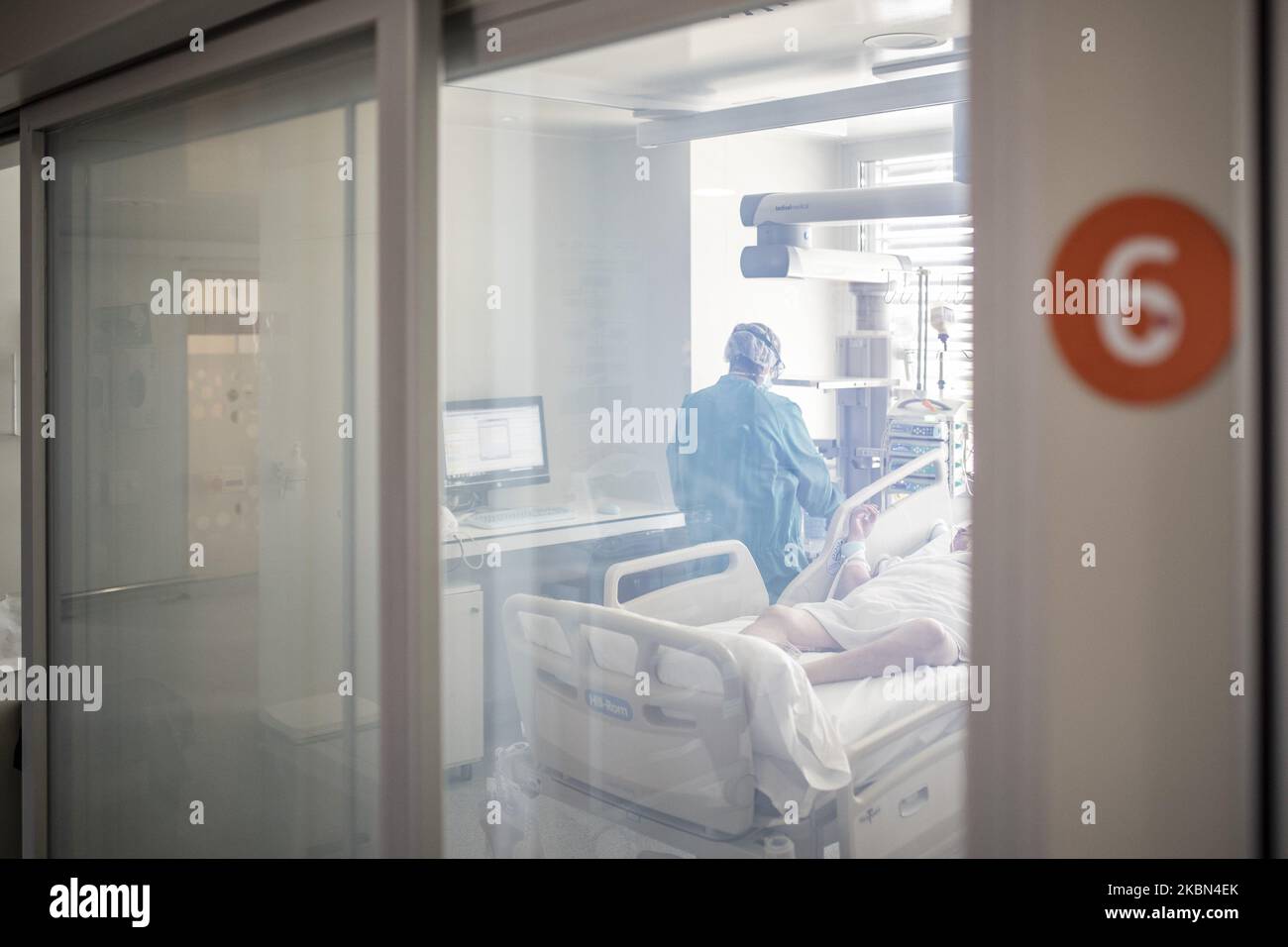 Healthcare personnel attend to a patient admitted to the ICU Intensive