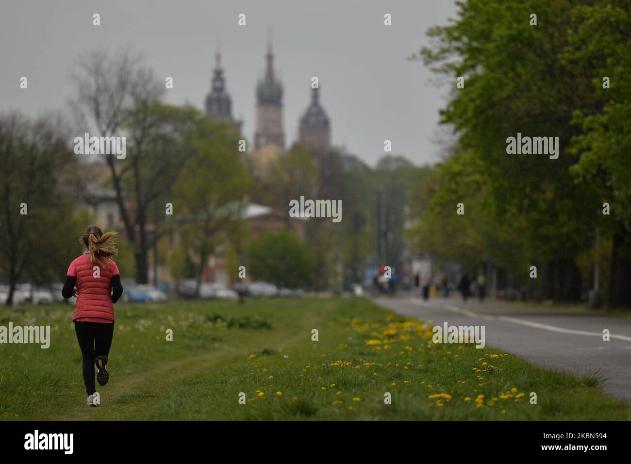 A lady seen jogging in Blonia Park in Krakow. Rain has returned to Krakow area and changeable weather with colder temperatures is predicted for this bank holiday weekend. On Friday, May 1, 2020, in Krakow, Poland. (Photo by Artur Widak/NurPhoto) Stock Photo