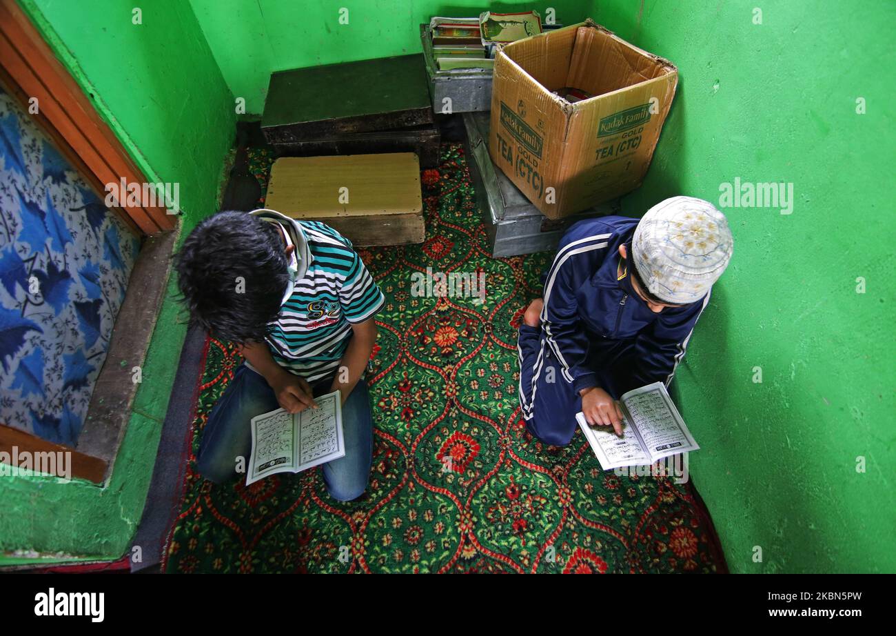 Kashmiri boys are seen reciting the holy Quran in an orphanage on the 7th day of Ramadan on the outskirts of Srinagar, Kashmir on May 01, 2020.Strict restrictions continue to remain in place across the Kashmir valley after the Indian Prime Minister Narendra Modi extended the lockdown across the country till May 03 to fight the COVID-19 coronavirus pandemic. Authorities across the Kashmir valley have ordered closure of all religious places as a preventive measures to stop the spread of COVID-19 coronavirus. (Photo by Faisal Khan/NurPhoto) Stock Photo