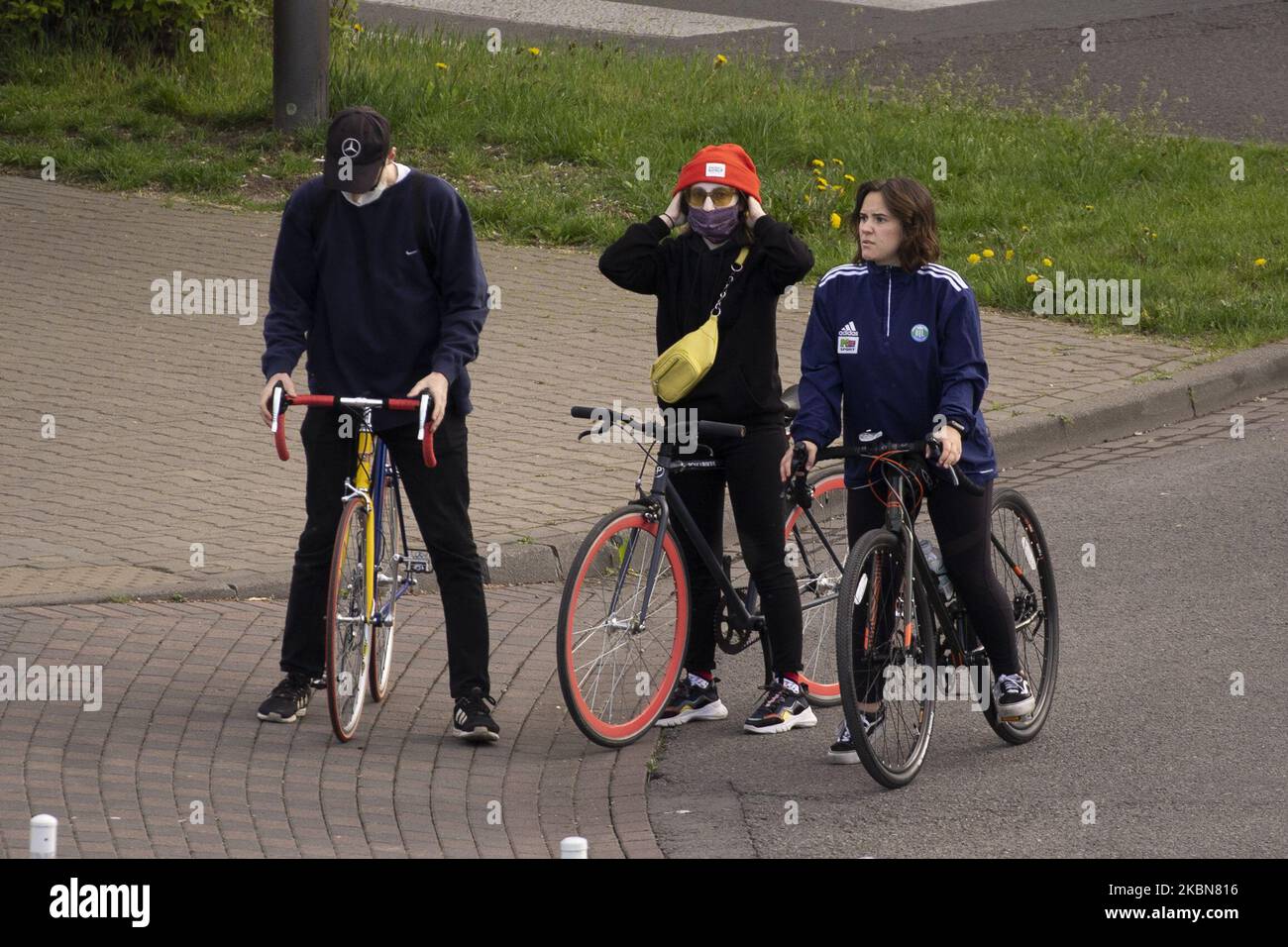 Cyclists, some wearing masks are seen in Warsaw, Poland on May 2, 2020. The Polish government has announced it will allow the opening of shopping malls on May 4 and pre-schools on May 6 less than two weeks ahead of scheduled persidential elections despite strong opposition. (Photo by Jaap Arriens/NurPhoto) Stock Photo