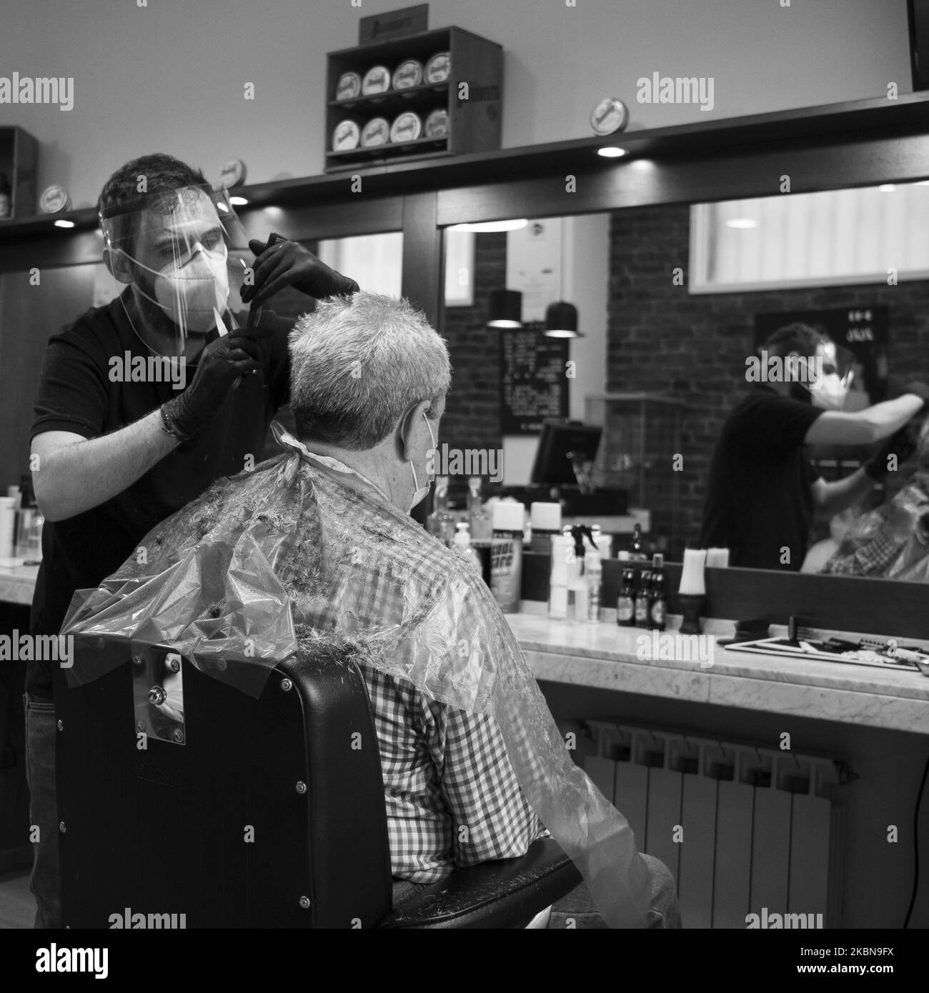A man gets a haircut in a hairdresser as the country officially embarks