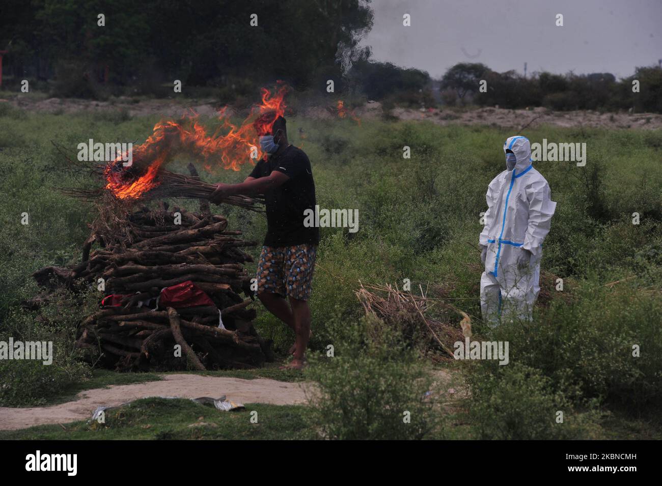 A mourn relative performs prayers and rituals before cremation of the ...