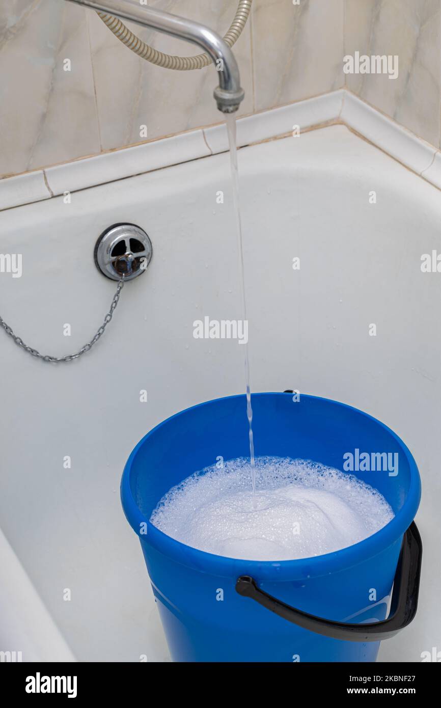 tap water fills a bucket in the bathroom Stock Photo Alamy