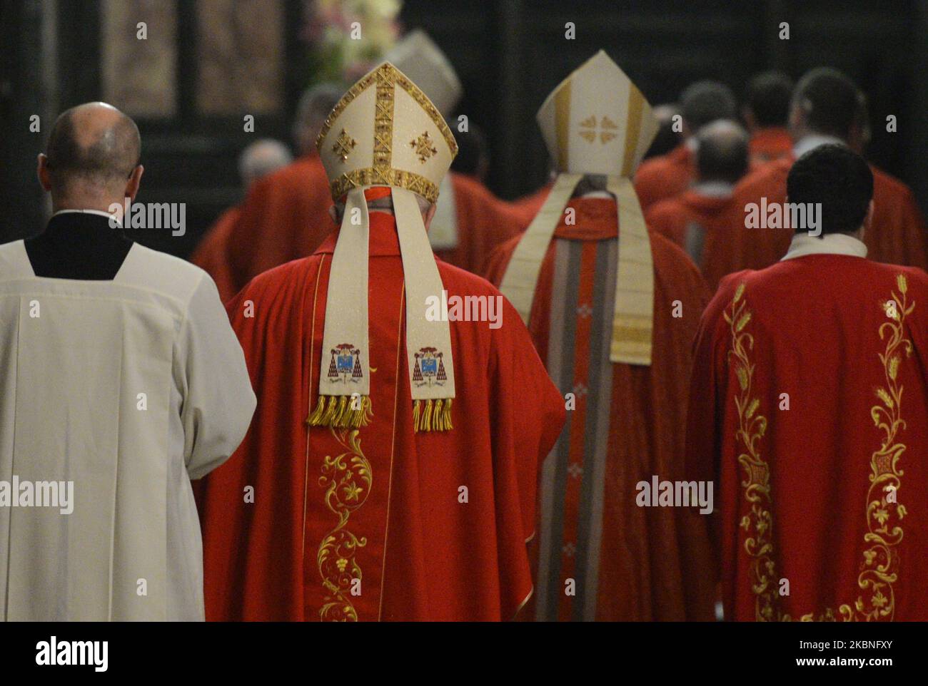 Cardinal, and priests walk to the sacristy after the mass on