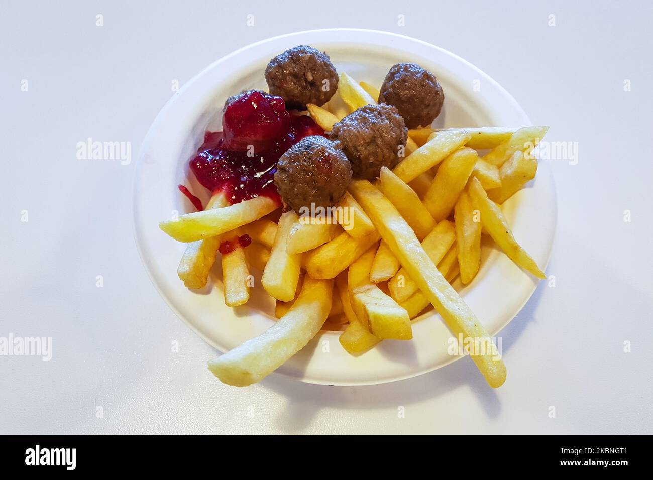 Ikea classic meal with Swedish meatballs, French fries and lingonberry sauce is served in Ikea