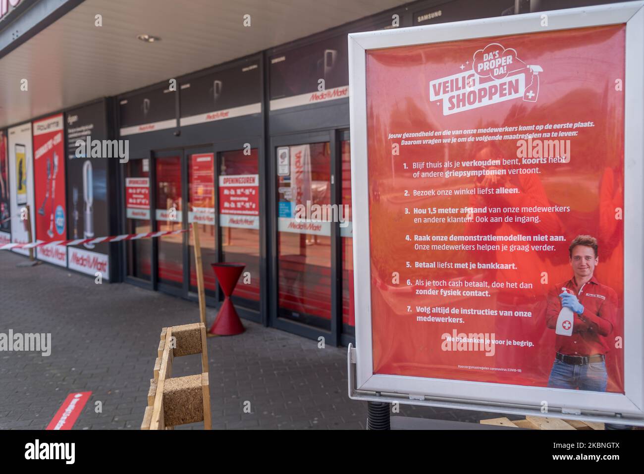 The entrance of Media markt with stickers to help people keep their  distance in Oostakker, Belgium