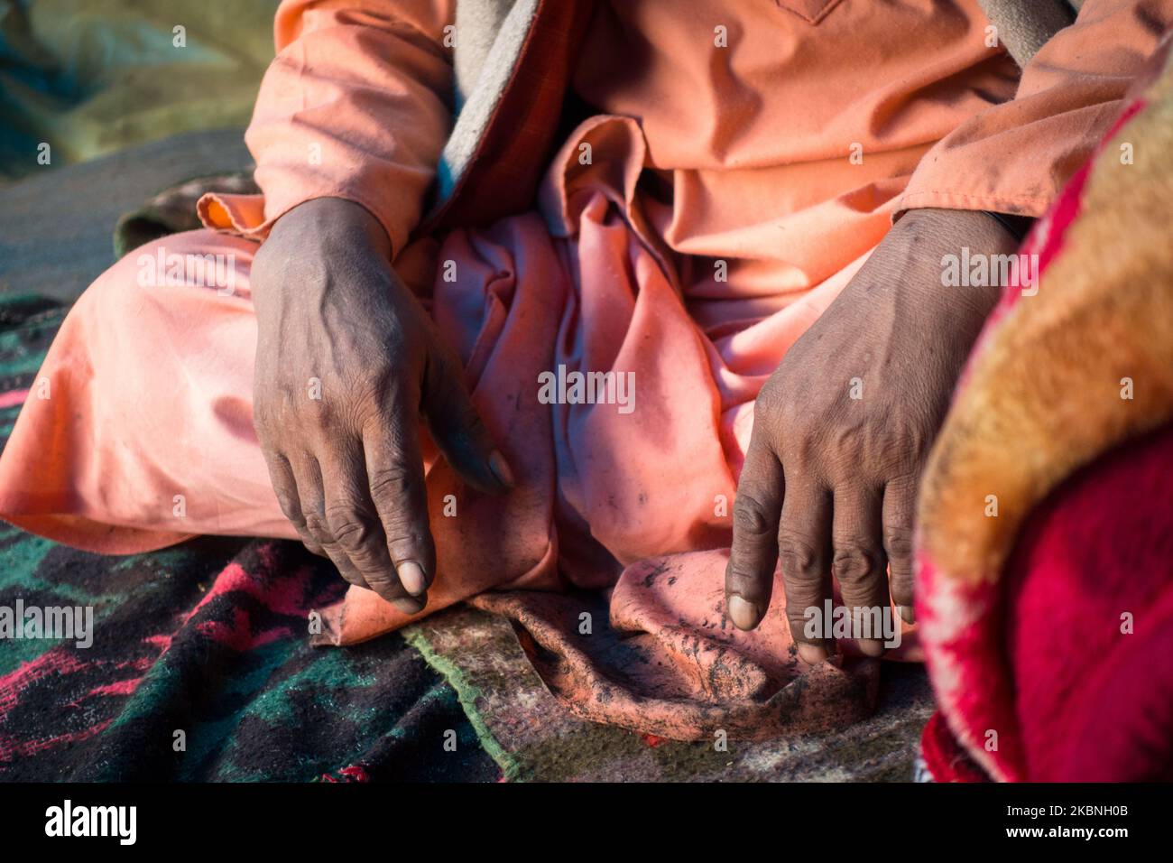 July 14th 2022, Himachal Pradesh India. Closeup of hands of an of an Indian Sadhu in traditional saffron attire during Shri khand Mahadev Kailash Yatr Stock Photo