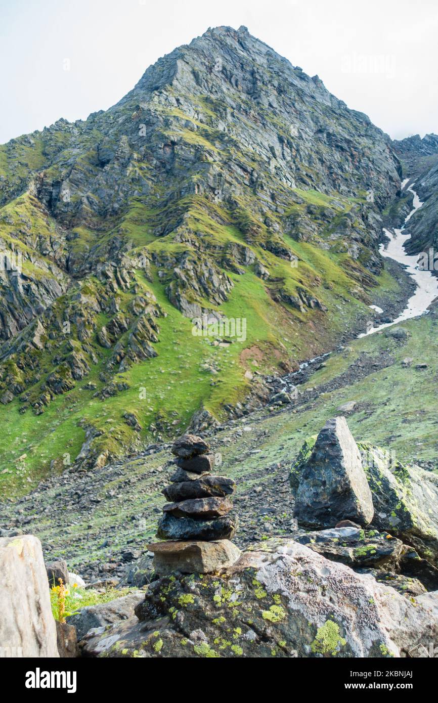 Shiva Linga made of rocks, a symbol of Lord Shiva in Hindu Mythology with Glacier mountains In the background. Shrikhand Mahadev Kailash Yatra in the Stock Photo