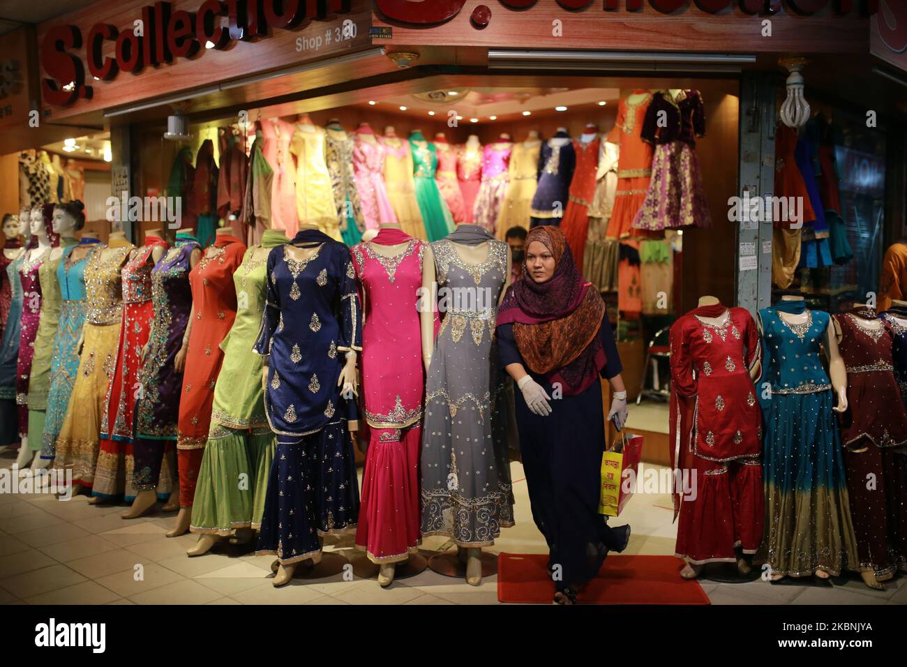 Residents buy clothes at a shop ahead of EidulFitr after shopping