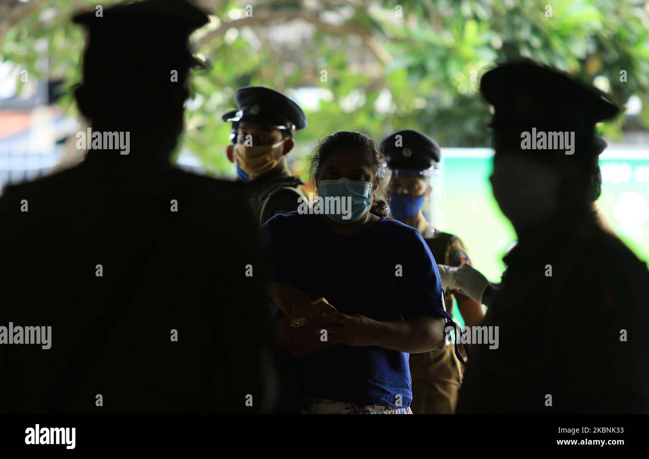 A Sri Lankan commuter under goes inspection by Sri Lankan police