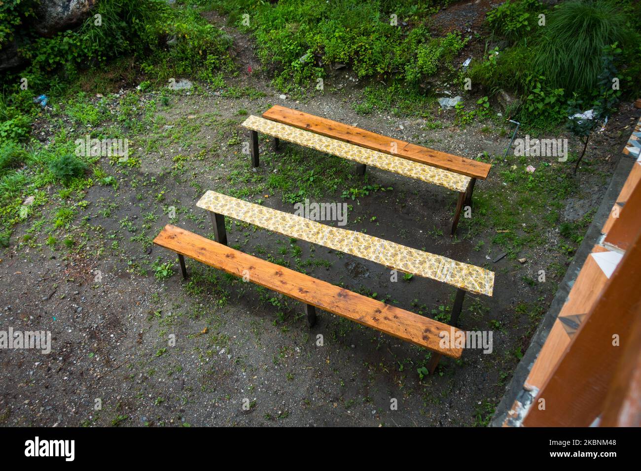 Empty Park bench made out of local wood blocks in rural India. Hill station In Himachal Pradesh,India Stock Photo