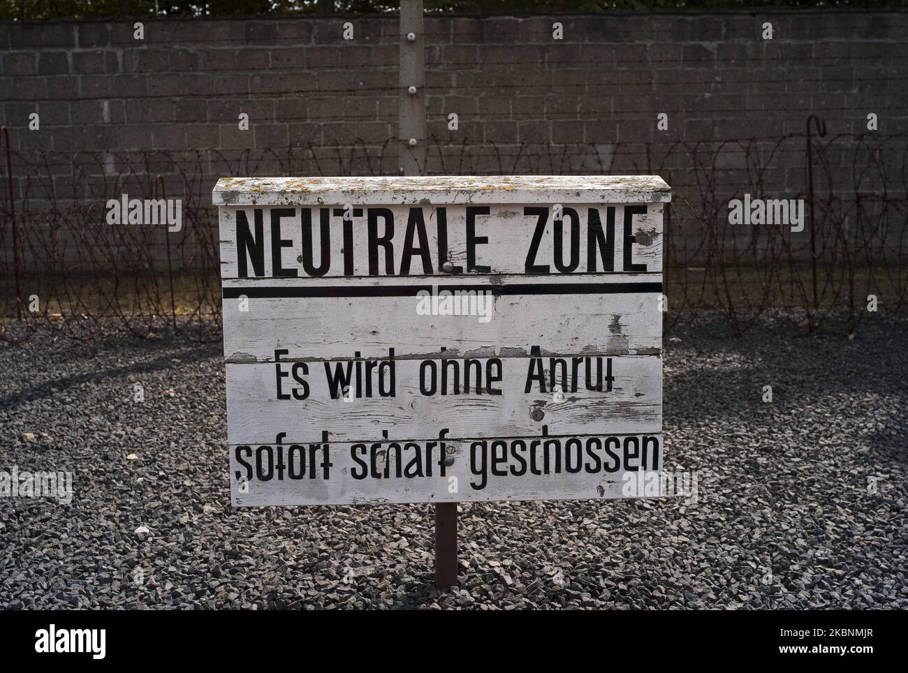 A sign that reads ''Neutrale Zone - Es wird ohne Anruf sofort scharf geschossen'' (Neutral Zone - Immediate live fire without warning'' is seen in the Sachsenhausen concentration camp, located in the town of Oranienburg, Brandenburg, Germany, on August 30, 2014, was built by the Nazis in 1936 to confine political opponents, Jews, prisoners of war. Today is a Memorial and Museum. (Photo by Oscar Gonzalez/NurPhoto) Stock Photo