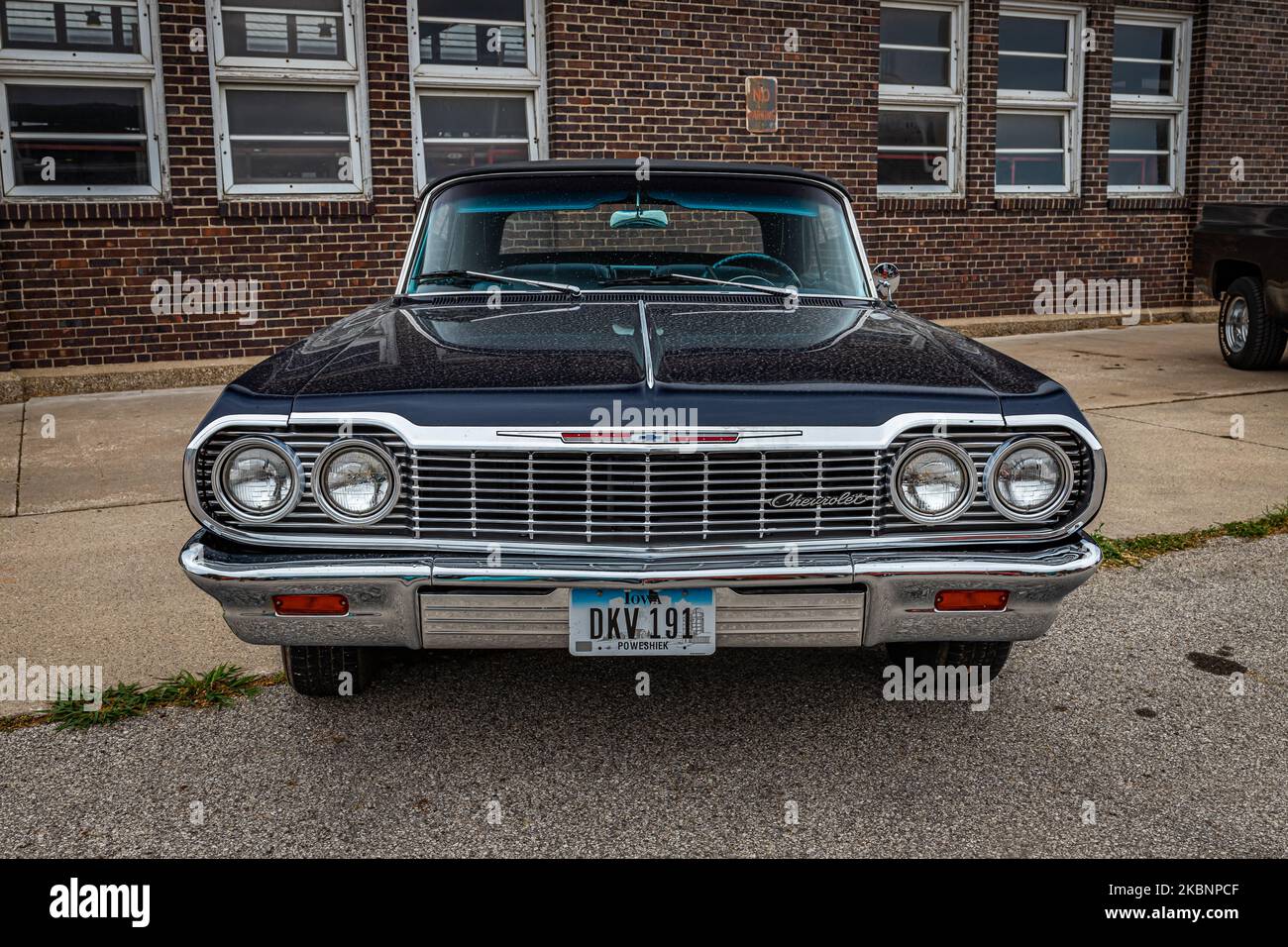 Des Moines, IA - July 01, 2022: High perspective front view of a 1964 Chevrolet Impala Convertible at a local car show. Stock Photo