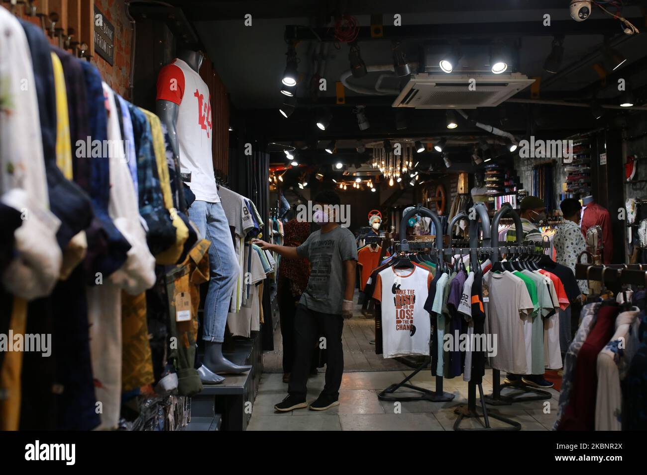 Residents buy clothes at a shop ahead of EidulFitr after shopping
