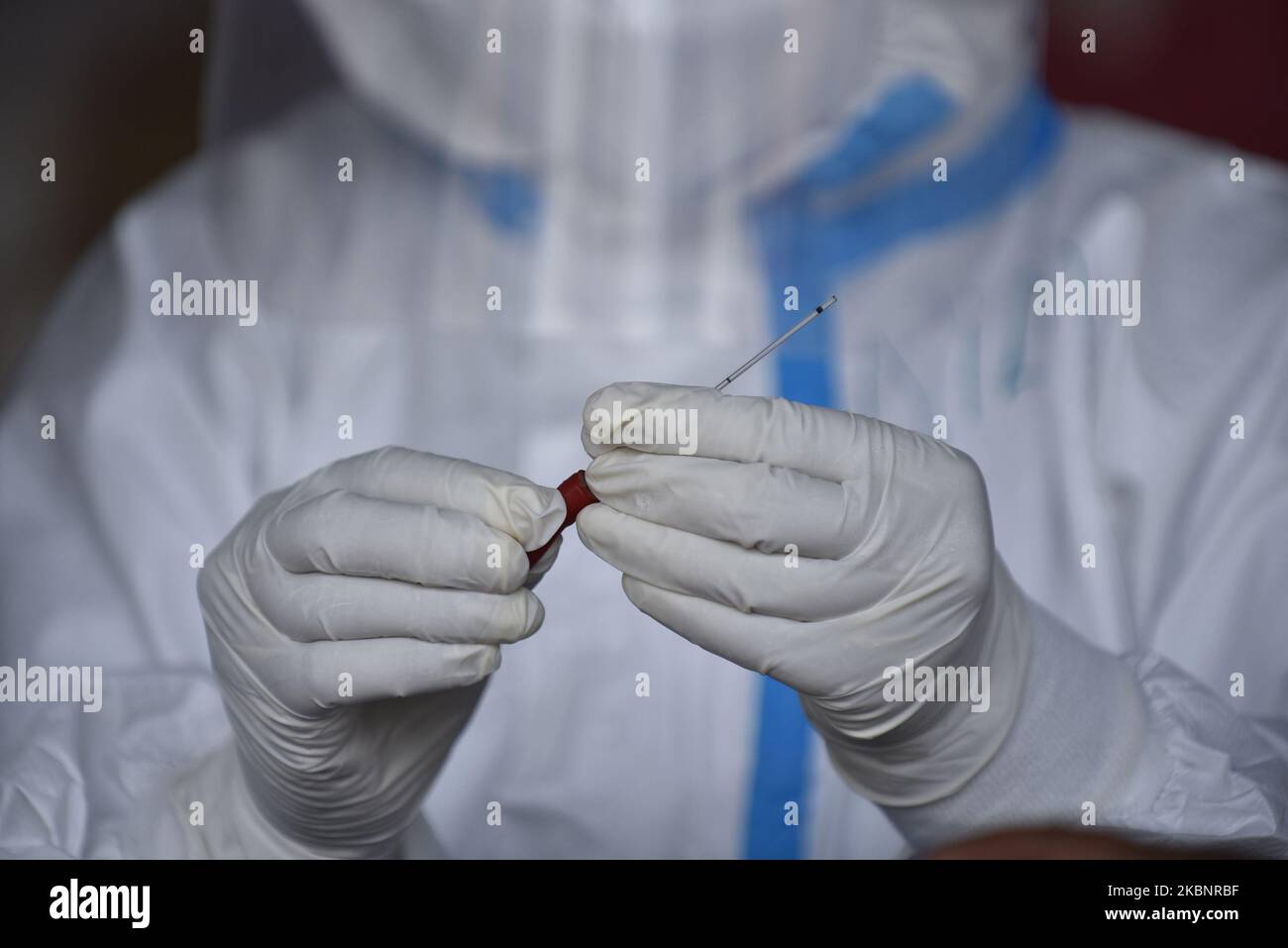 A Nepalese Health personnel arranging rapid diagnostic test (RDT) kit ...