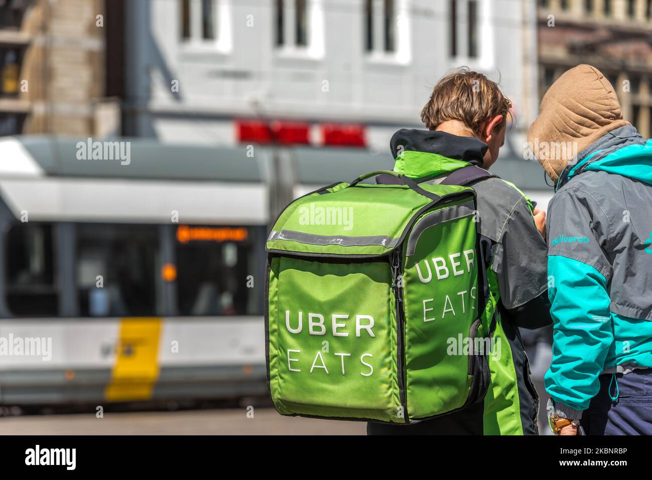 Uber eats deliverer wait outside for a fast food order in Ghent, Belgium on May 14, 2020. As Belgium takes steps in easing Restrictions, Restaurant and cafe are not allowed to open to customers only fast food and take away is allowed. restaurants and restaurants may not reopen before June 8. (Photo by Jonathan Raa/NurPhoto) Stock Photo