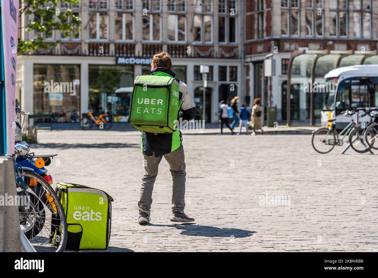 Uber eats deliverer wait outside for a fast food order in Ghent, Belgium on May 14, 2020. As Belgium takes steps in easing Restrictions, Restaurant and cafe are not allowed to open to customers only fast food and take away is allowed. restaurants and restaurants may not reopen before June 8. (Photo by Jonathan Raa/NurPhoto) Stock Photo