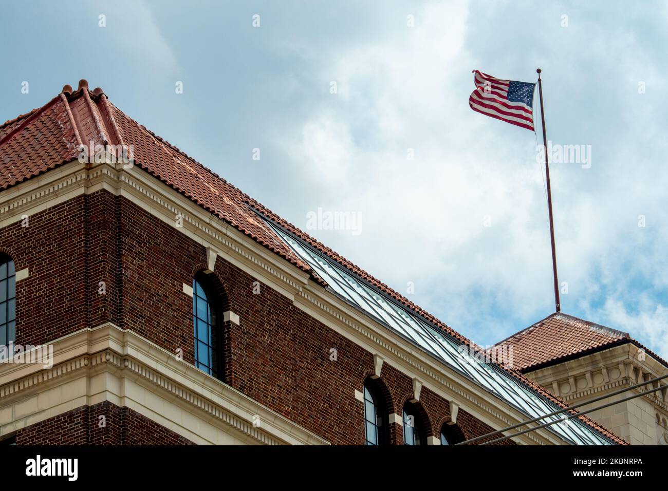An American flag blows in the wind atop the Baldwin Building in the wake of the Coronavirus COVID-19 pandemic, Thursday, May 14, 2020, in Cincinnati, Ohio, United States. (Photo by Jason Whitman/NurPhoto) Stock Photo