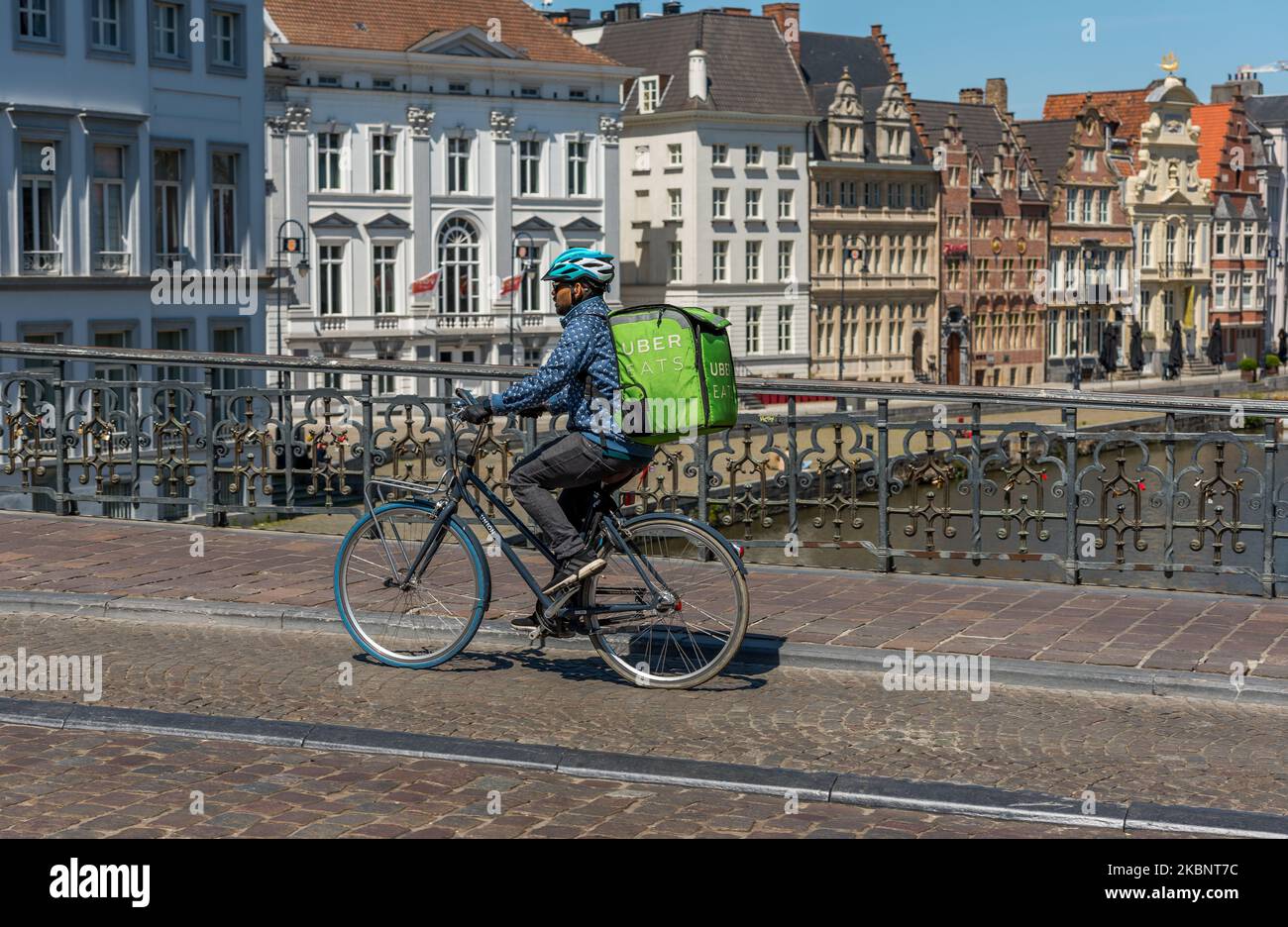 Uber Eats delivery courier on bicycle on his way to deliver fast food