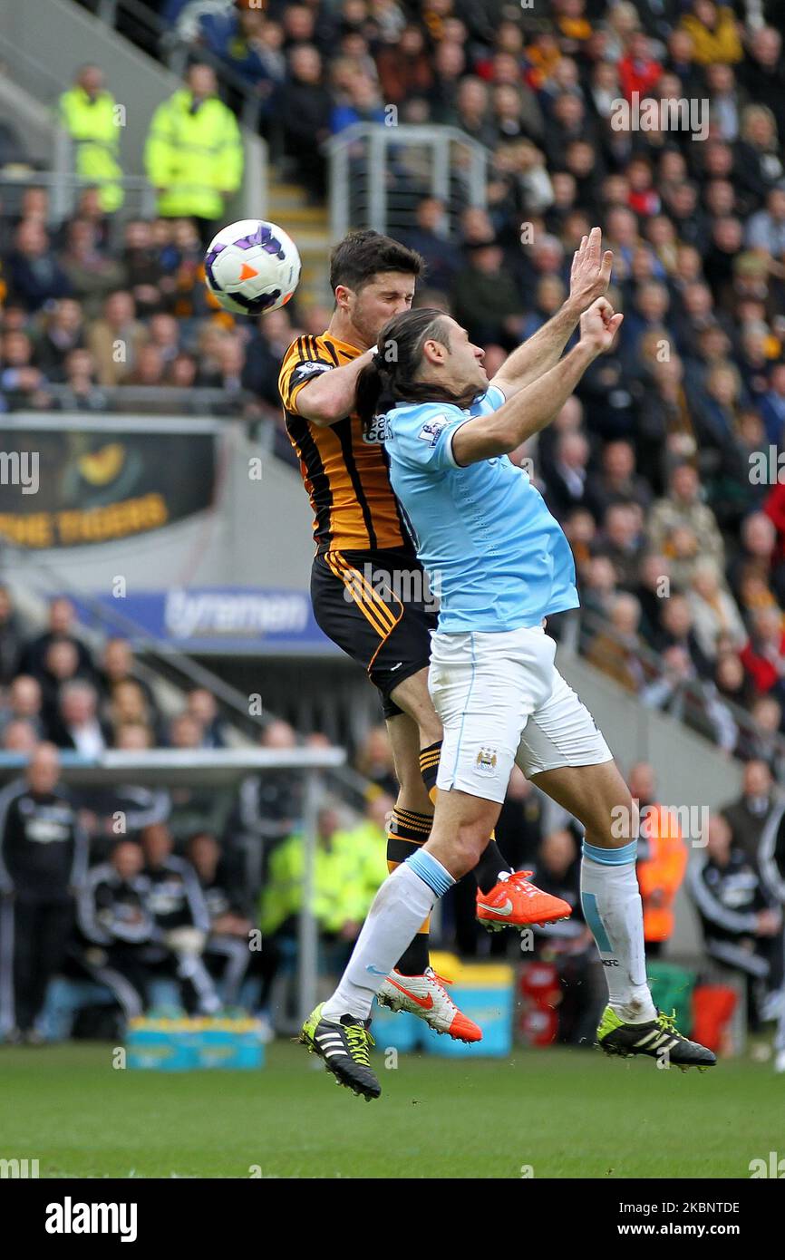 Shane Long of Hull City contests a header with Martin Demichelis of Manchester City during the Premier League match between Hull City and Manchester City at the KC Stadium, Kingston upon Hull on Saturday 15th March 2014 (Photo by Mark Fletcher/MI News/NurPhoto) Stock Photo